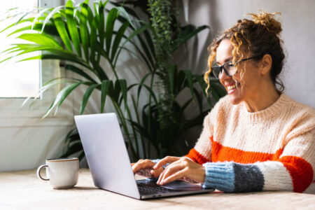 happy social media manager working on a laptop