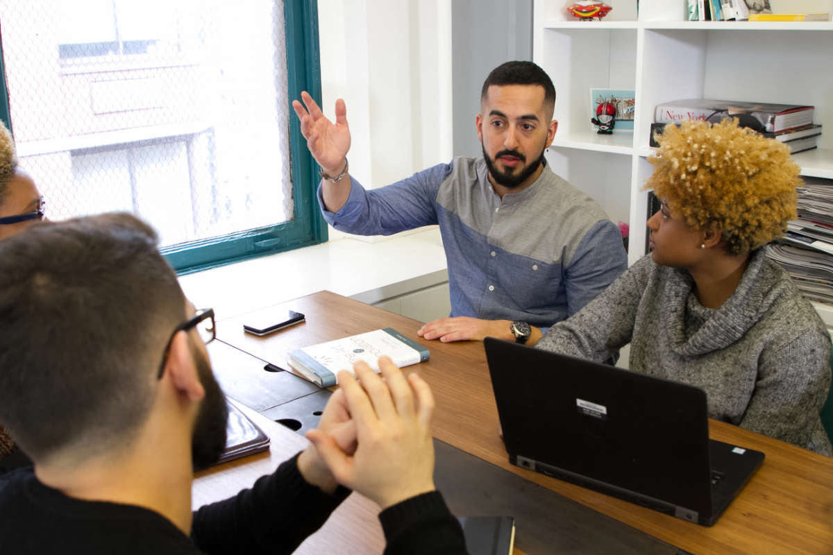 digital marketing assistant working with their team discussing ideas