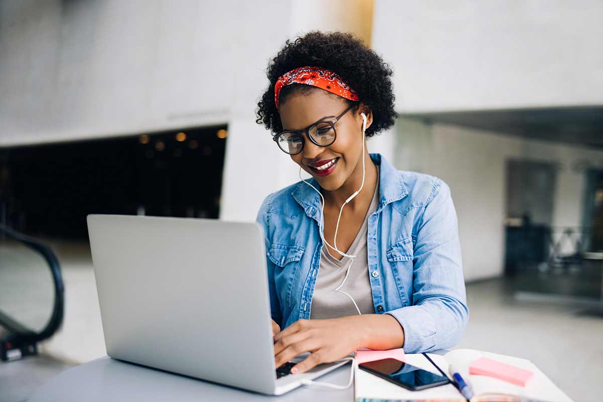 a digital marketing professional working intently on a laptop, analyzing data and planning marketing strategies