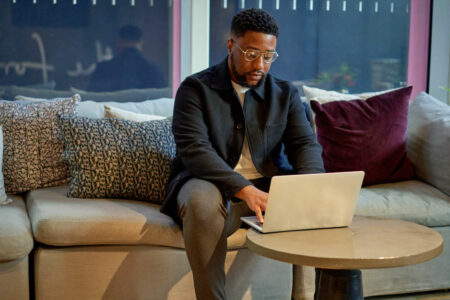 freelance writing pro working on a laptop at a co-working space