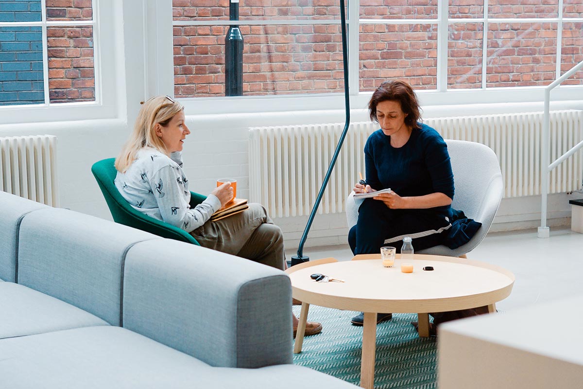 Two women chatting at a networking event in London. 